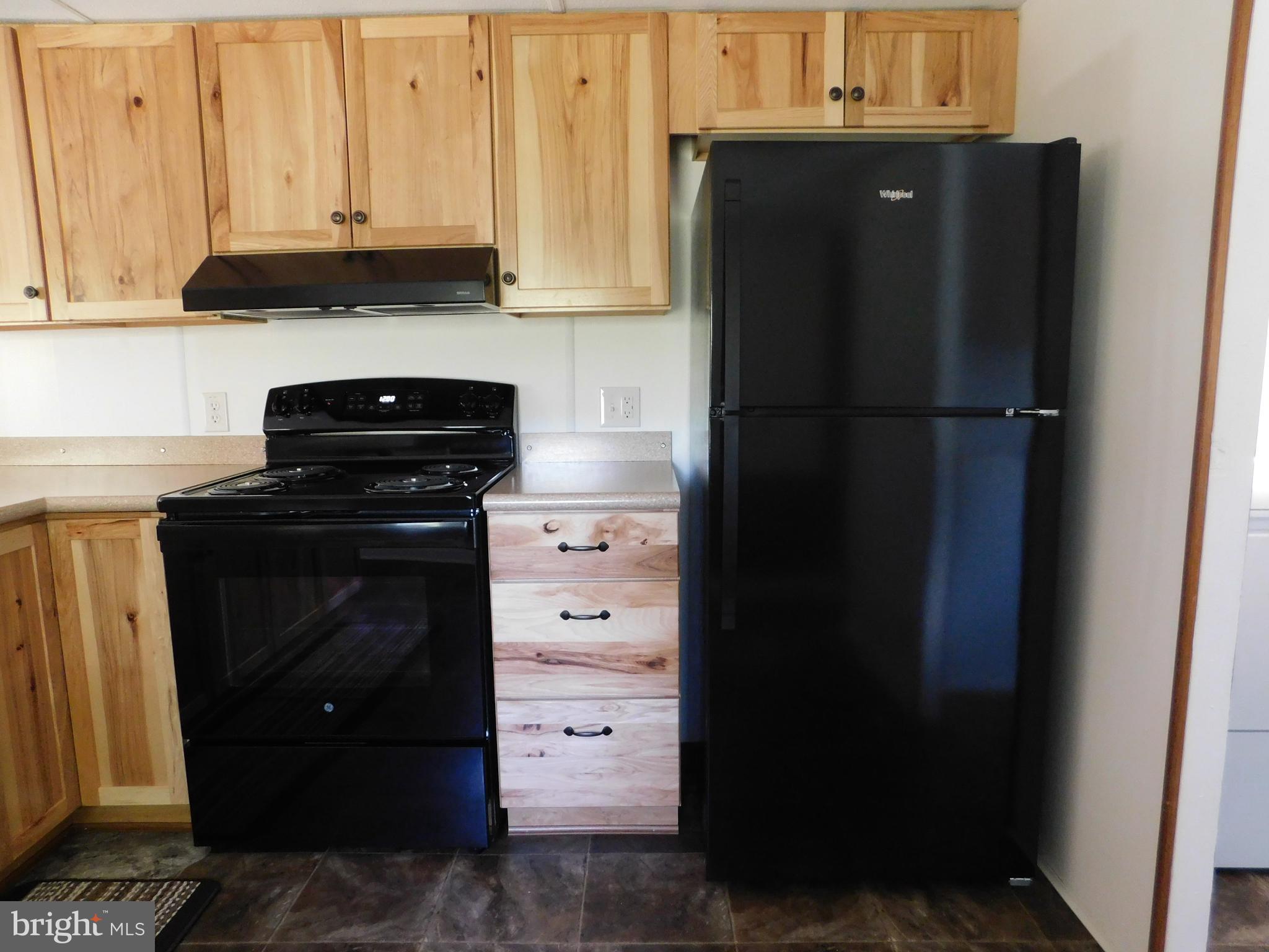 192 AA Rogers Road Augusta, WV 26704 - Photo 12 of 34 a kitchen with a refrigerator and a stove