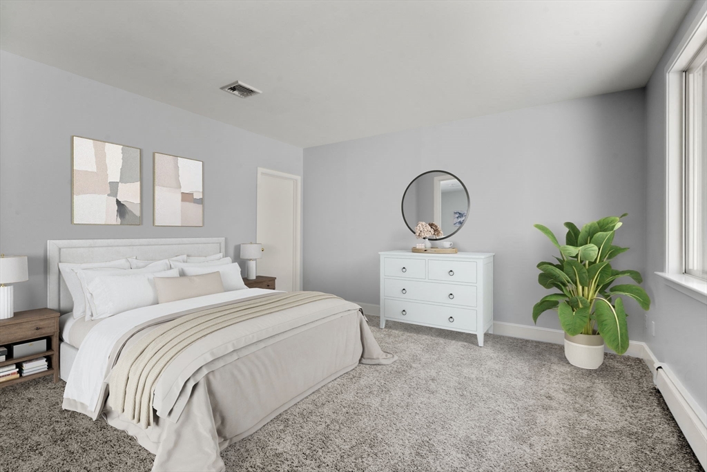 214 Allandale Road, Unit B Boston, MA 02467 - Photo 19 of 35 a bedroom with a bed and a potted plant on dresser