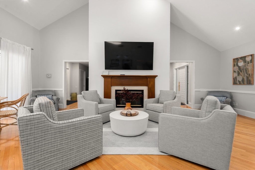 214 Allandale Road, Unit B Boston, MA 02467 - Photo 28 of 35 a living room with furniture a fireplace and a flat screen tv