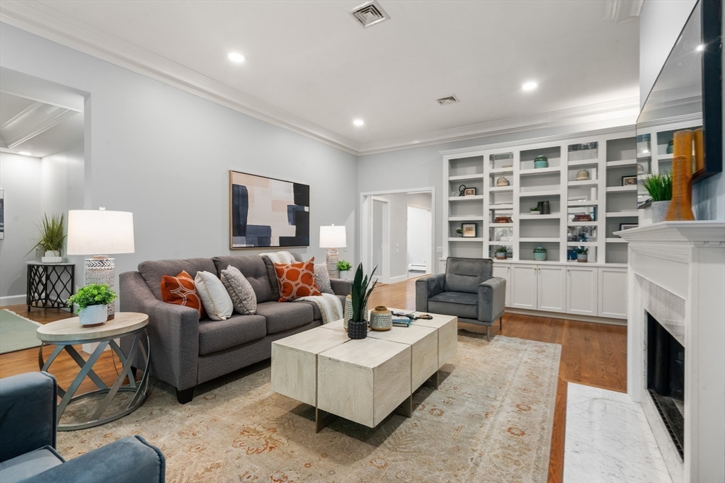 214 Allandale Road, Unit B Boston, MA 02467 - Photo 7 of 35 a living room with furniture and a fireplace