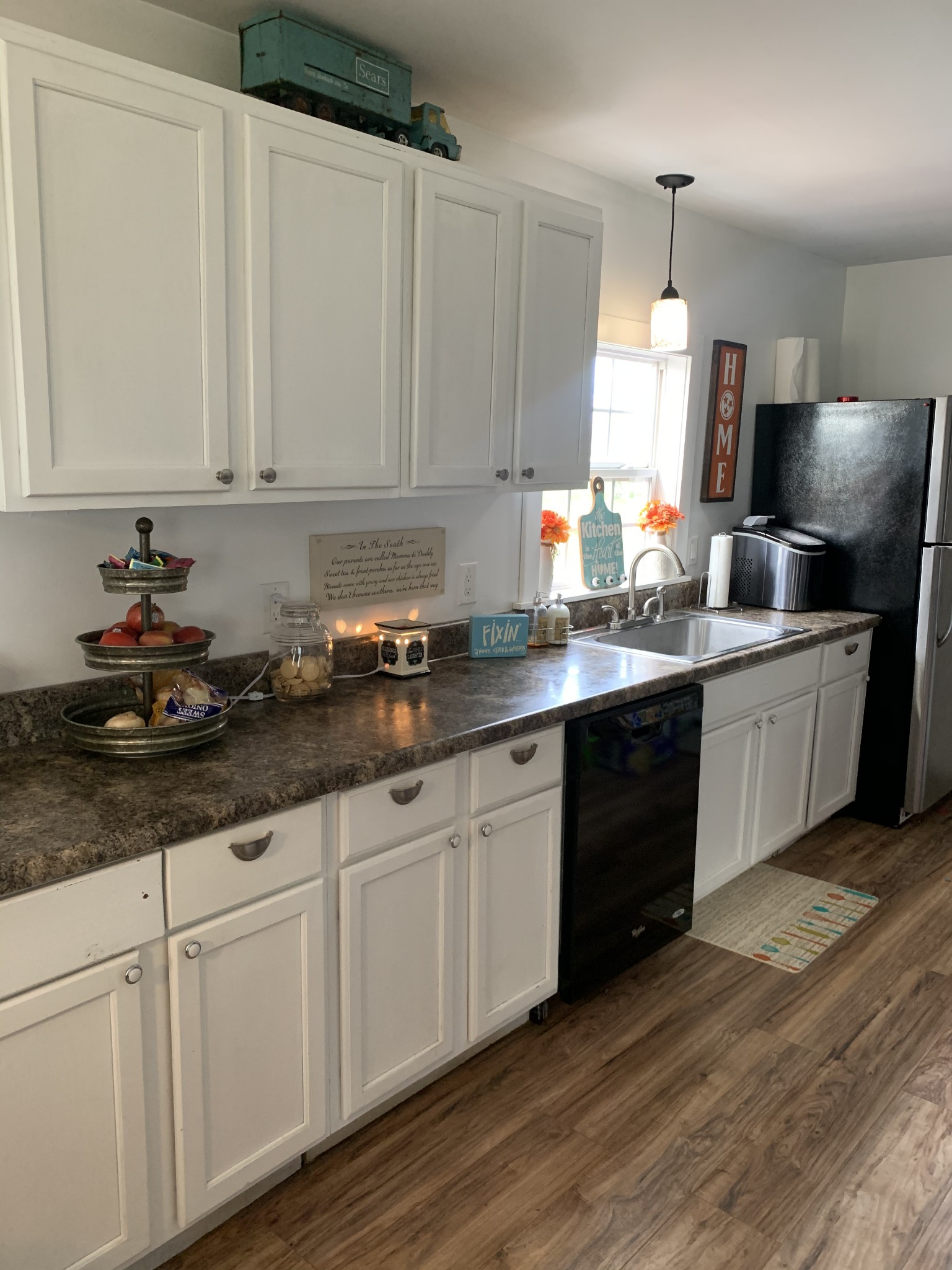 62 Asa Smith Road Ardmore, TN 38449 - Photo 7 of 24 a kitchen with stainless steel appliances granite countertop a sink a stove and white cabinets with wooden floor