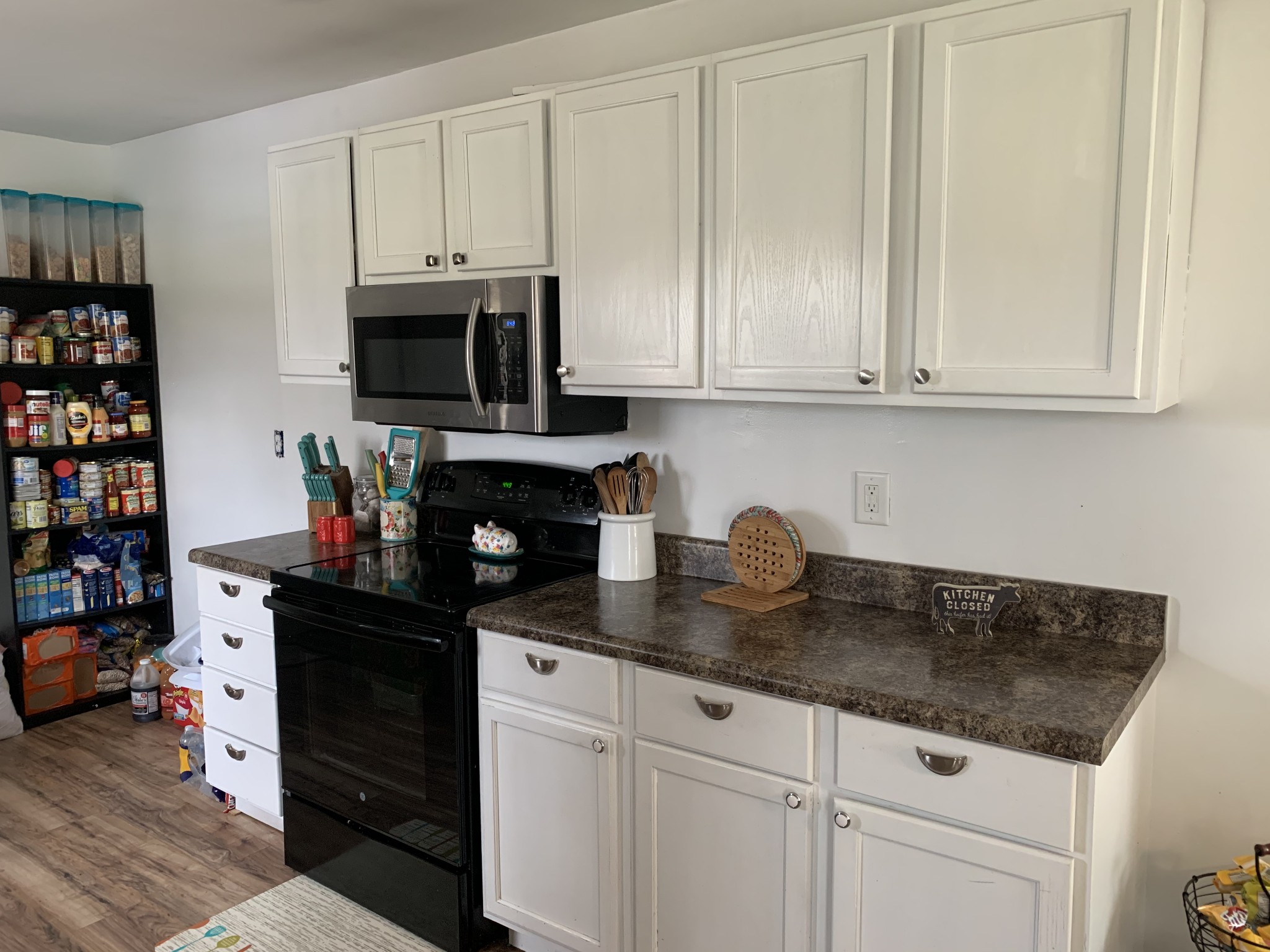 62 Asa Smith Road Ardmore, TN 38449 - Photo 8 of 24 a kitchen with stainless steel appliances granite countertop a stove a sink and white cabinets