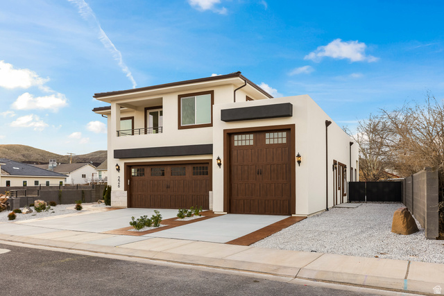 226 East 1100 North Hurricane, UT 84737 - Photo 12 of 49 Contemporary home with stucco siding, concrete driveway, a balcony, and a mountain view
