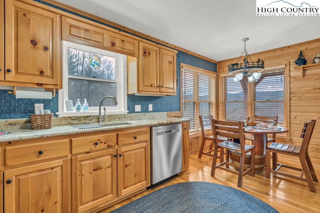 883 Wagon Ridge Road Ferguson, NC 28624 - Photo 11 of 50 a kitchen with granite countertop a sink cabinets and wooden floor