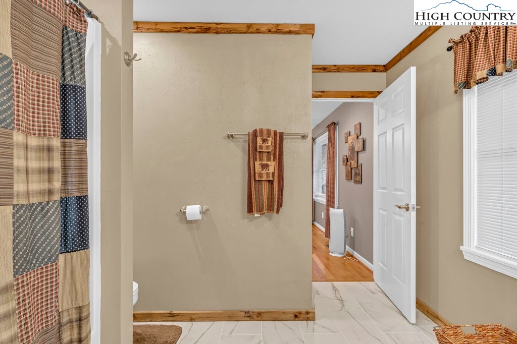 883 Wagon Ridge Road Ferguson, NC 28624 - Photo 19 of 50 a door of a house with wooden floor and stairs