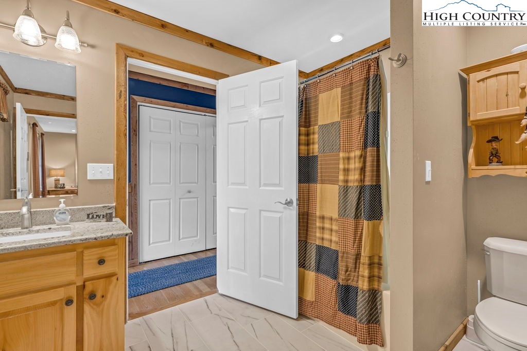 883 Wagon Ridge Road Ferguson, NC 28624 - Photo 20 of 50 a bathroom with a sink and a mirror