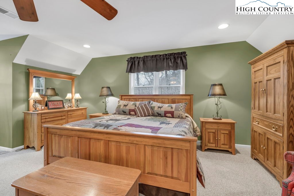 883 Wagon Ridge Road Ferguson, NC 28624 - Photo 23 of 50 a bedroom with a bed and wooden floor