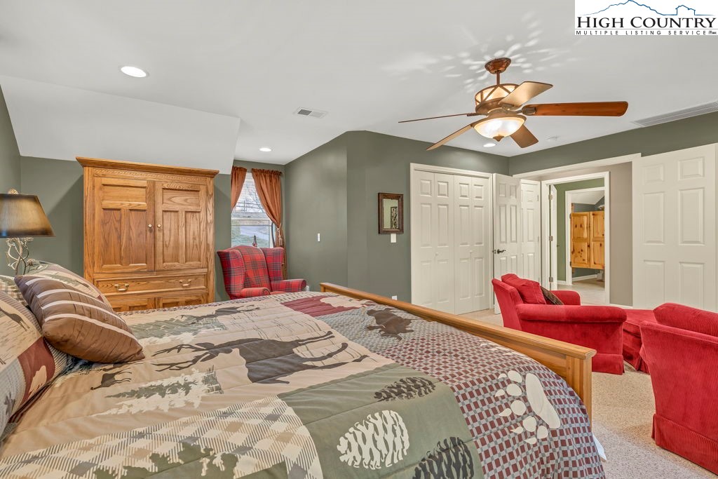 883 Wagon Ridge Road Ferguson, NC 28624 - Photo 25 of 50 a bedroom with a bed and a chandelier
