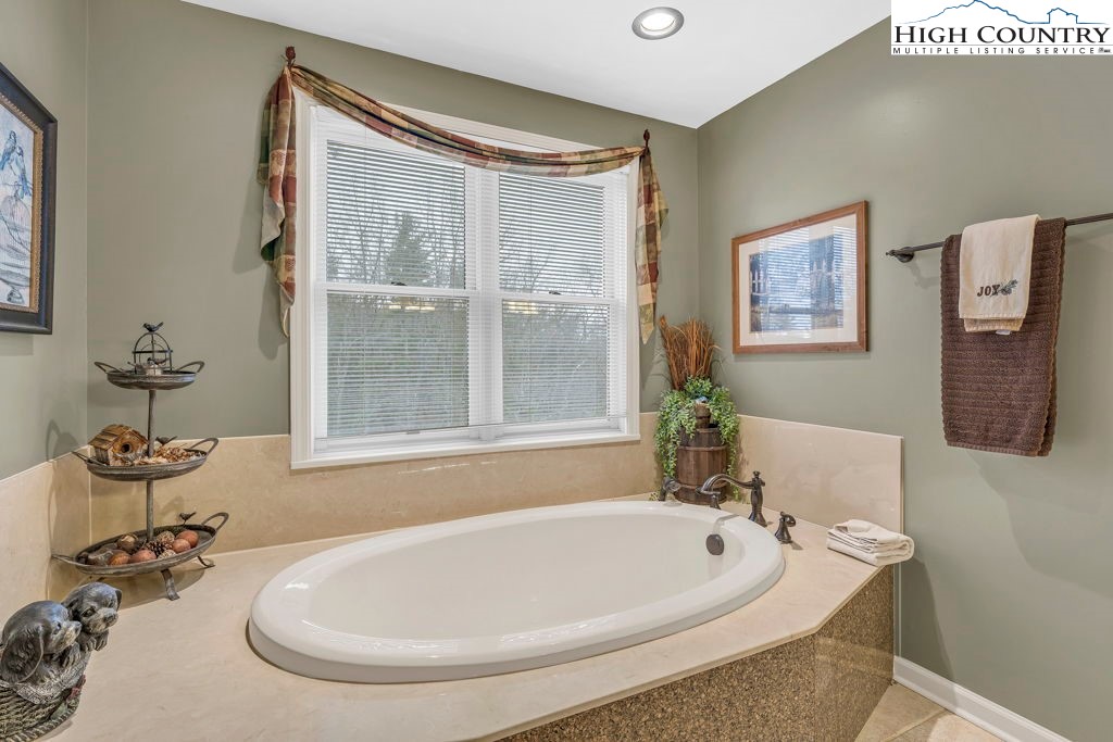 883 Wagon Ridge Road Ferguson, NC 28624 - Photo 27 of 50 a white bath tub sitting next to a white sink
