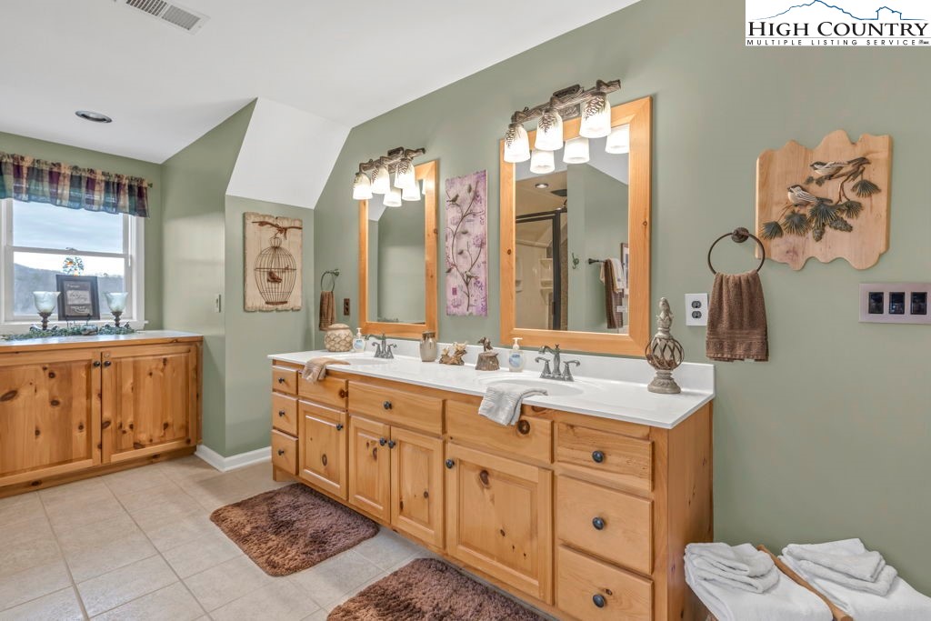 883 Wagon Ridge Road Ferguson, NC 28624 - Photo 28 of 50 a spacious bathroom with a double vanity sink mirror and