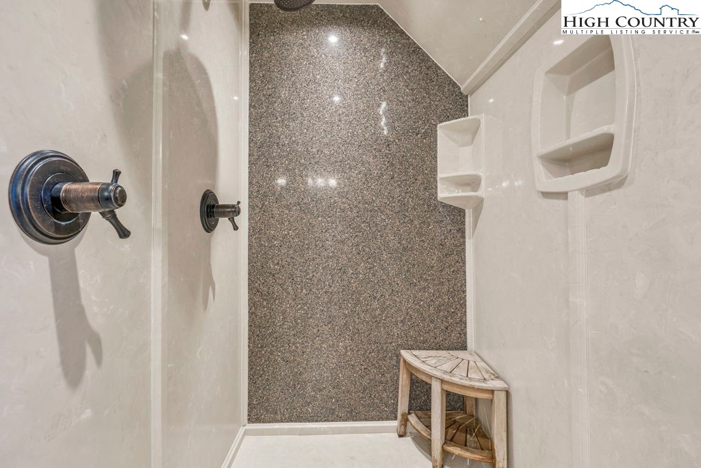 883 Wagon Ridge Road Ferguson, NC 28624 - Photo 29 of 50 a bathroom with a sink a mirror and shower