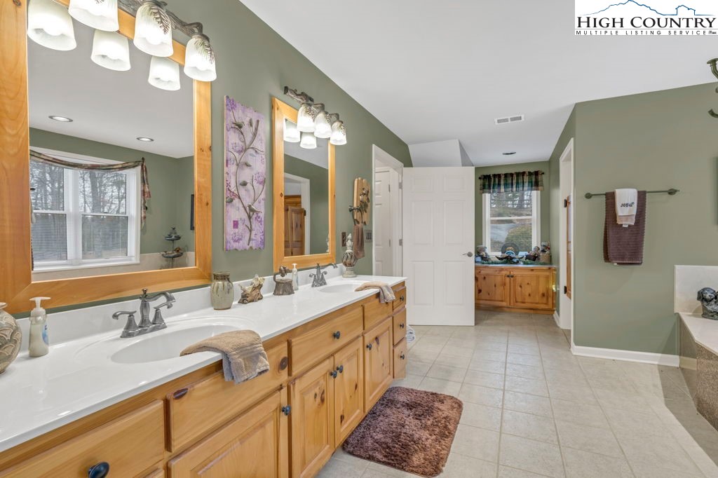 883 Wagon Ridge Road Ferguson, NC 28624 - Photo 30 of 50 a spacious bathroom with a double vanity sink mirror and double