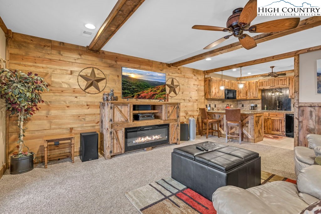 883 Wagon Ridge Road Ferguson, NC 28624 - Photo 32 of 50 a living room with fireplace furniture and a flat screen tv