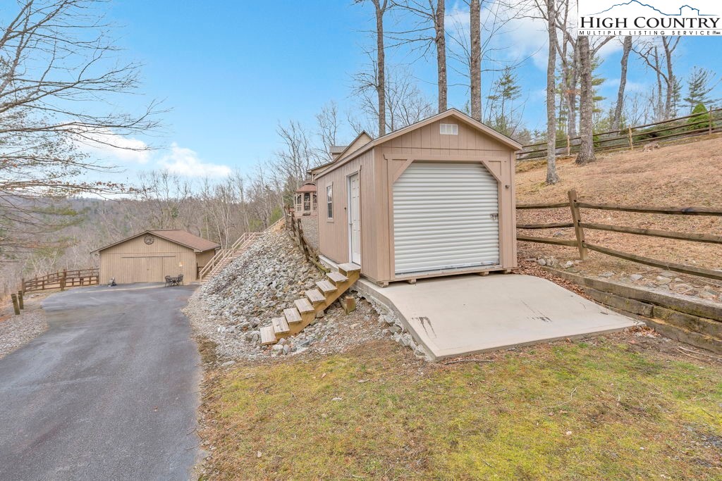 883 Wagon Ridge Road Ferguson, NC 28624 - Photo 44 of 50 a view of a house with a yard and garage