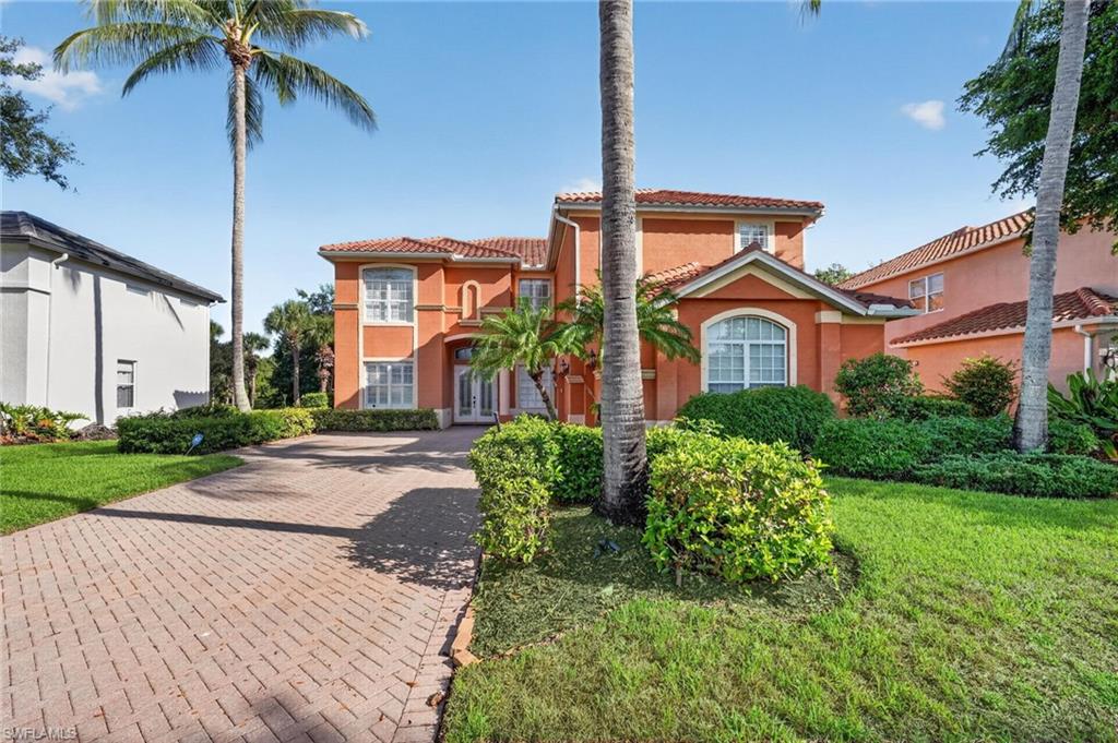 9970 Rookery Circle Estero, FL 33928 - Photo 1 of 50 Mediterranean-style architecture featuring a red tile roof and stucco exterior