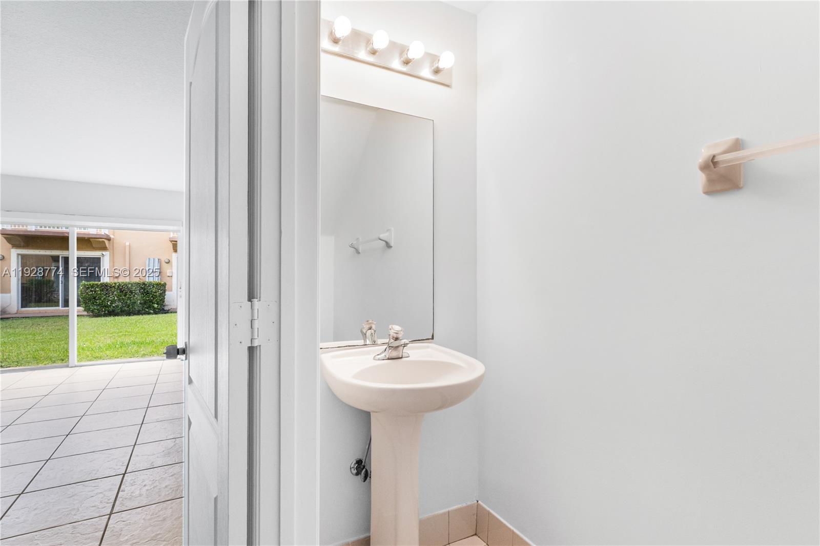 3168 Southwest 129th Way, Unit 151 Miramar, FL 33027 - Photo 12 of 21 a bathroom with a sink a mirror and a shower