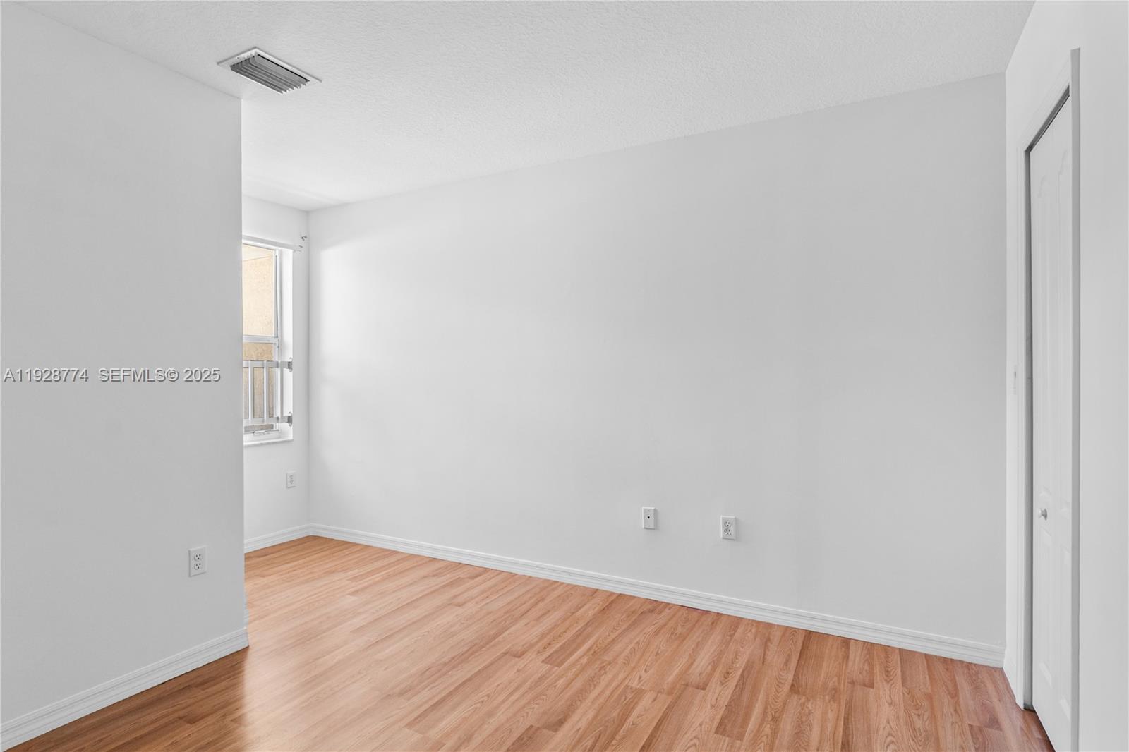 3168 Southwest 129th Way, Unit 151 Miramar, FL 33027 - Photo 19 of 21 a view of a room with wooden floor and white walls