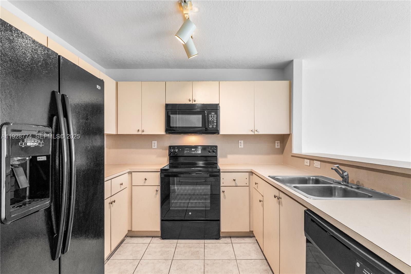 3168 Southwest 129th Way, Unit 151 Miramar, FL 33027 - Photo 6 of 21 a kitchen with a sink stove and refrigerator