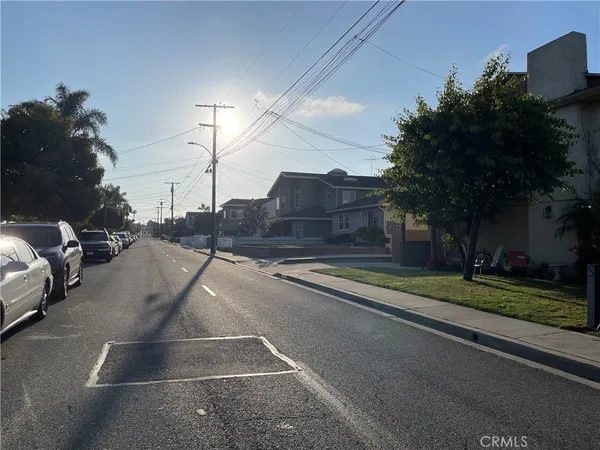 a view of a city street with a car parked on the road