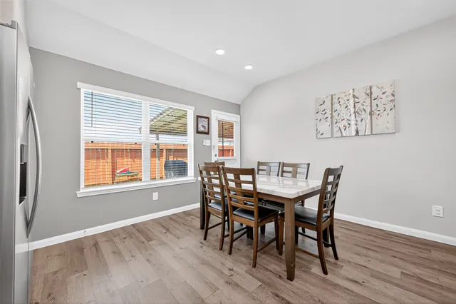 a view of a dining room with furniture and wooden floor