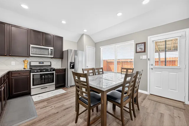 a view of a dining room with furniture and wooden floor