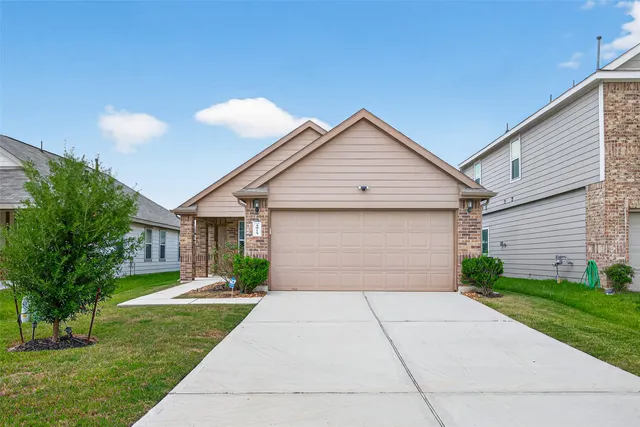 a front view of house with yard and green space