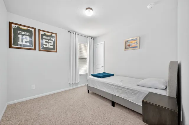 a spacious bedroom with a bed and a desk