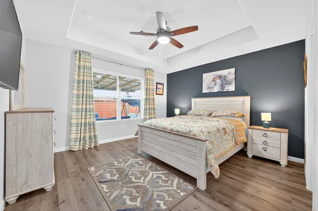 a bedroom with a bed and a large window