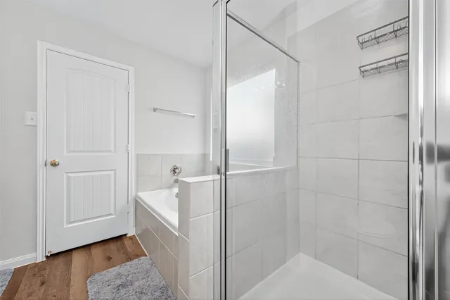 a bathroom with a bathtub and shower