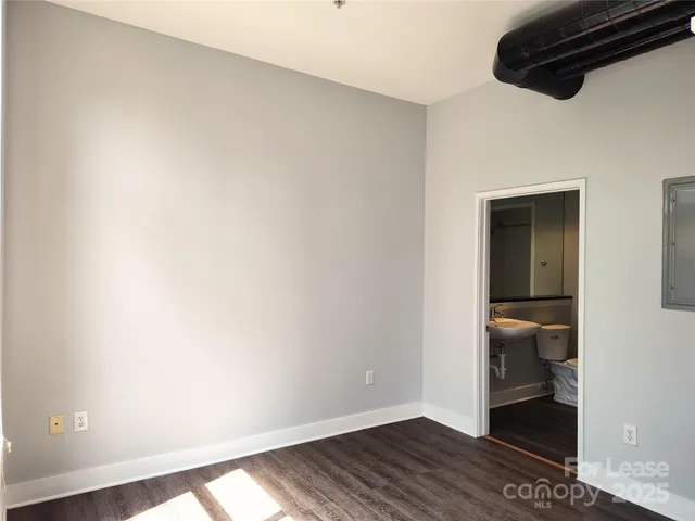 a view of hallway with wooden floor and closet
