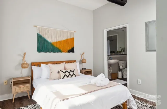 a bedroom with a bed and a painting on the wall