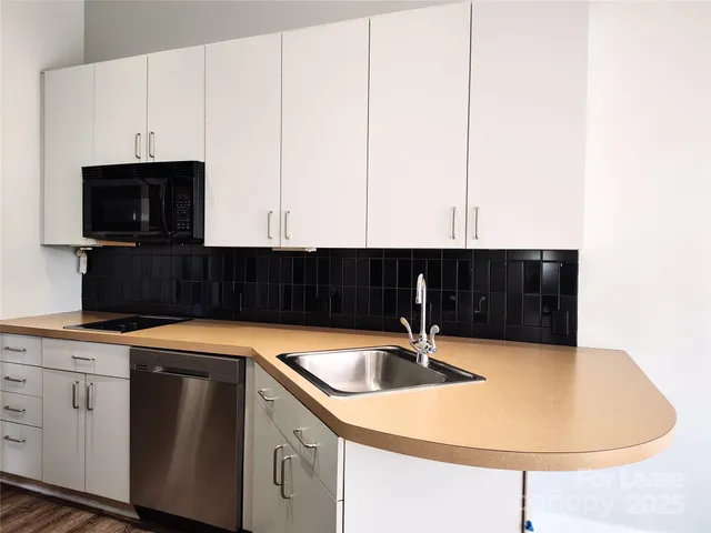 a kitchen with a sink and cabinets