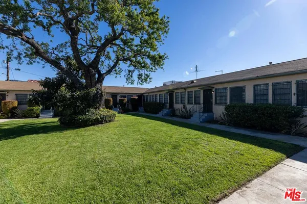 a view of house with a yard