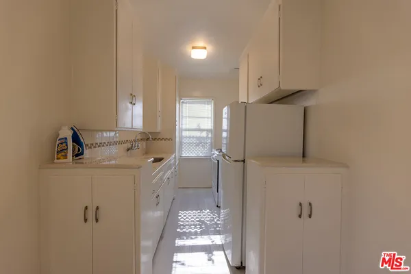 a stove top oven sitting inside of a kitchen