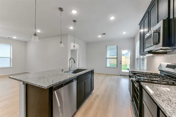 a bathroom with a granite countertop sink a large mirror and vanity
