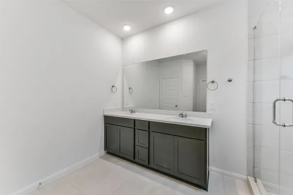 a bathroom with a shower sink double and mirror