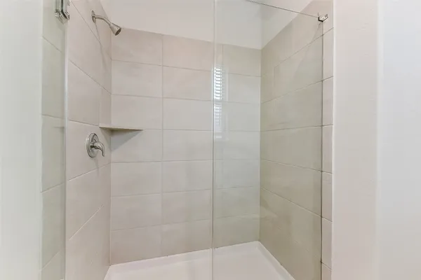 a view of an empty room with a ceiling fan and window