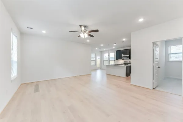 a view of kitchen with kitchen island a sink stainless steel appliances and cabinets