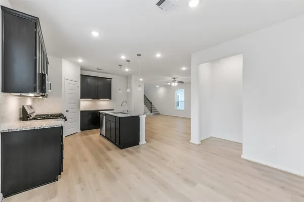 a large kitchen with stainless steel appliances microwave and stove