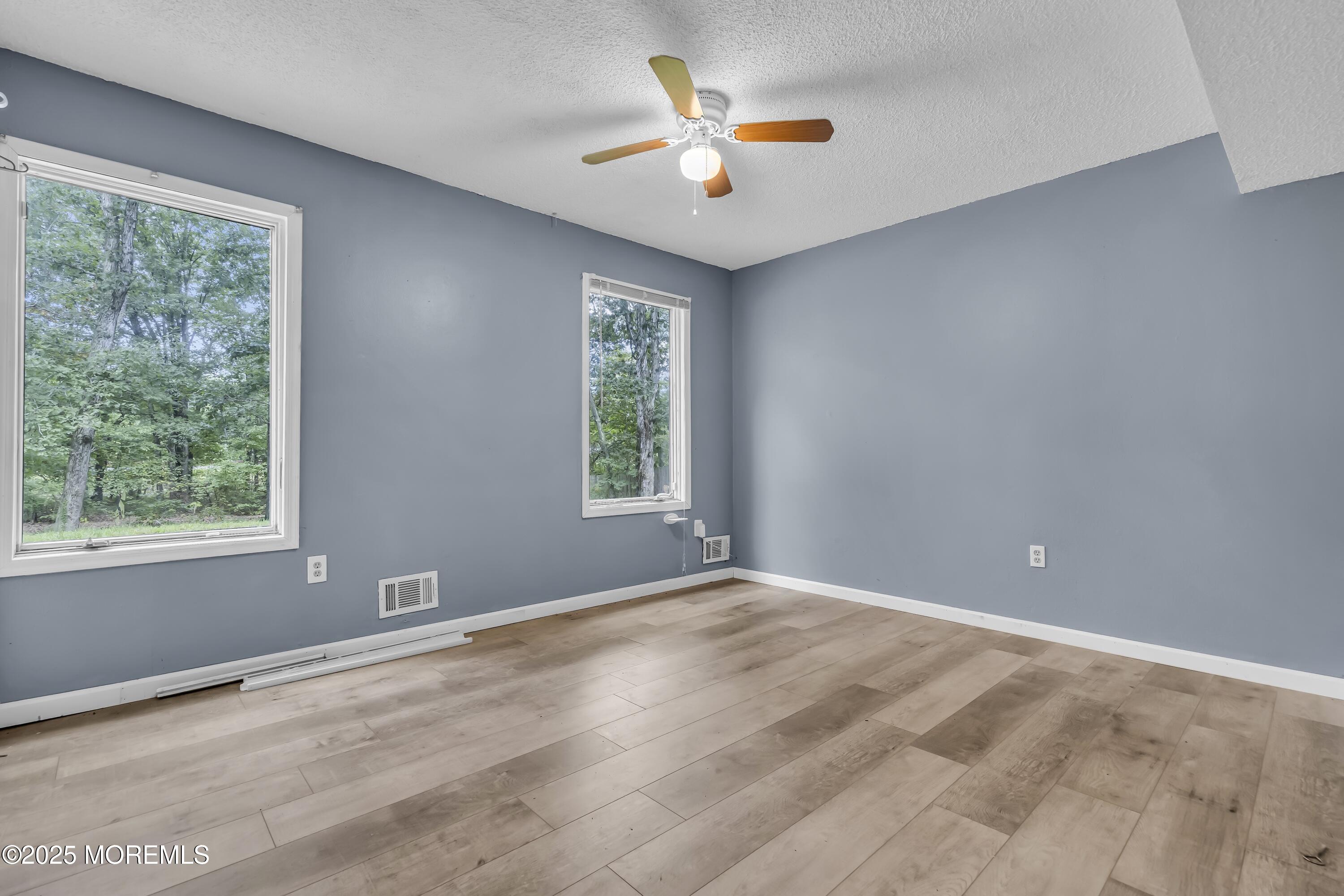 32 1st Street Barnegat, NJ 08005 - Photo 12 of 16 a view of a room with a window and a ceiling fan
