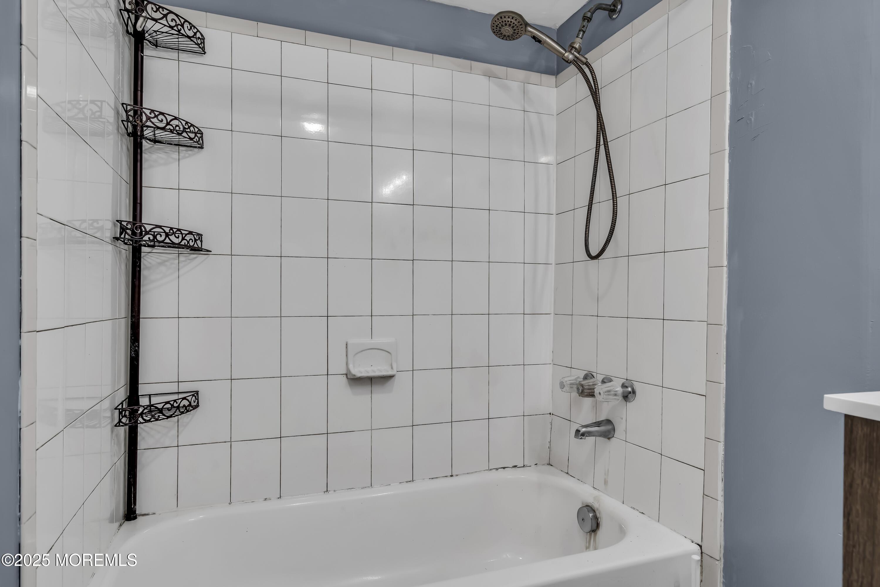 32 1st Street Barnegat, NJ 08005 - Photo 14 of 16 a bathroom with a bath tub with a shower