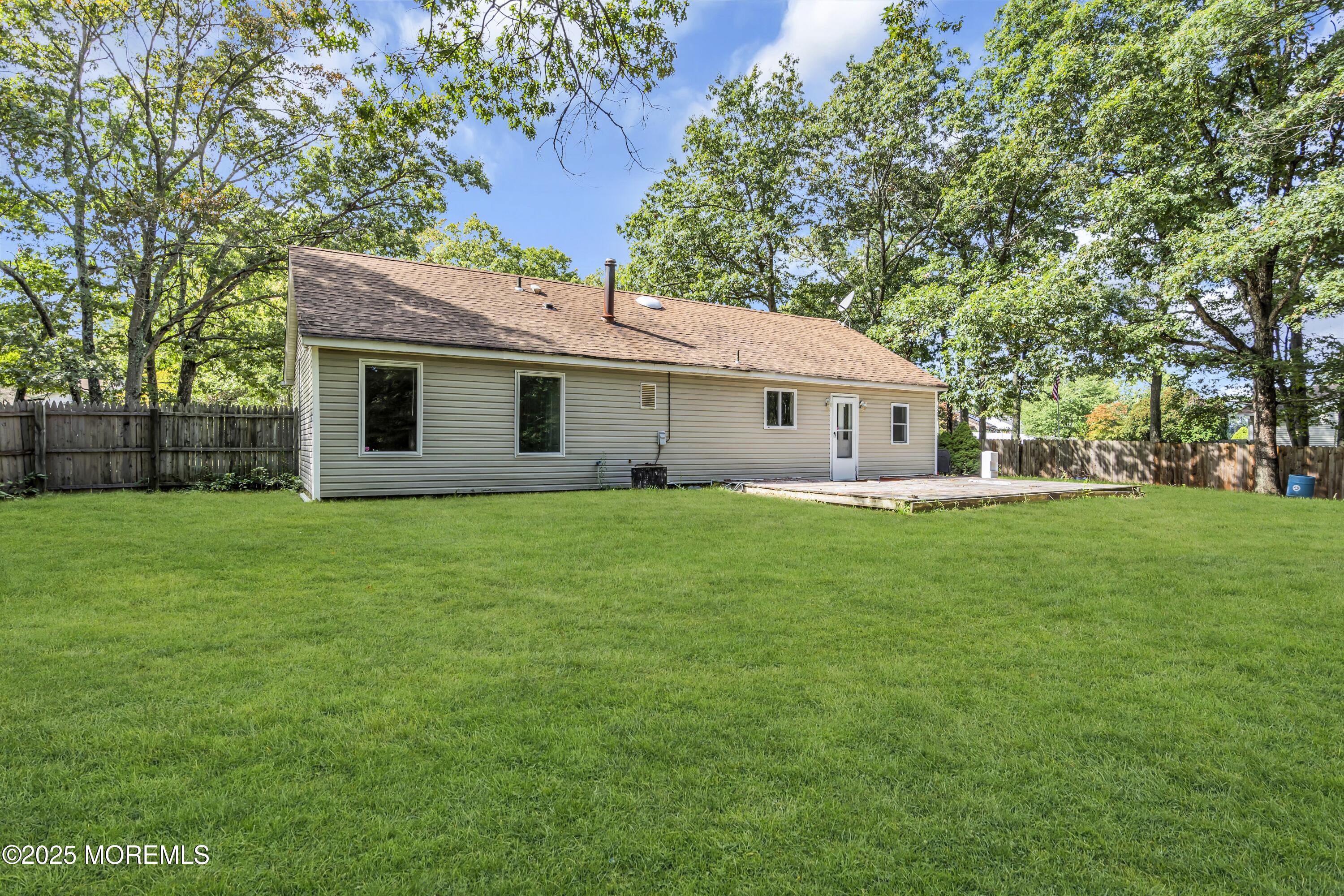 32 1st Street Barnegat, NJ 08005 - Photo 15 of 16 a front view of house with a garden