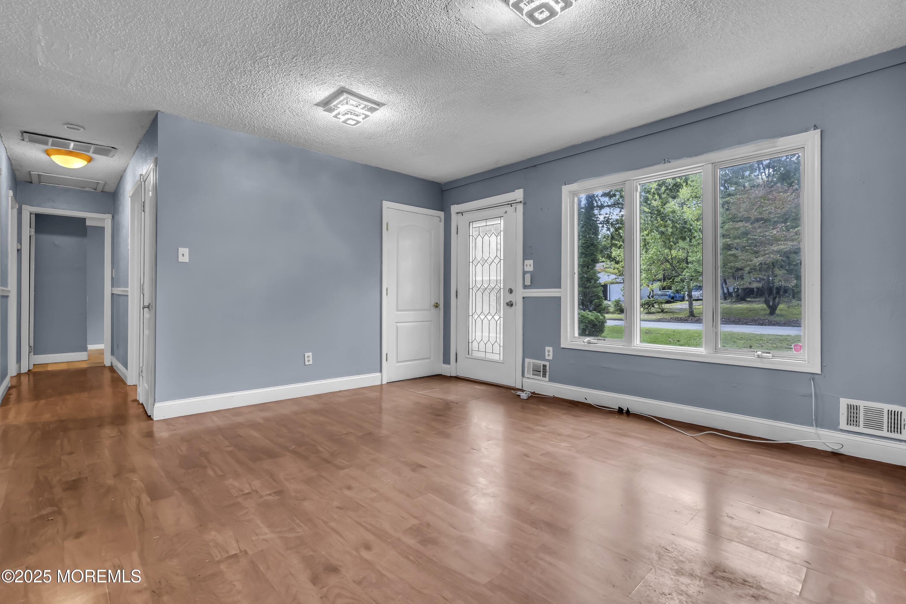 32 1st Street Barnegat, NJ 08005 - Photo 4 of 16 a view of an empty room with a window
