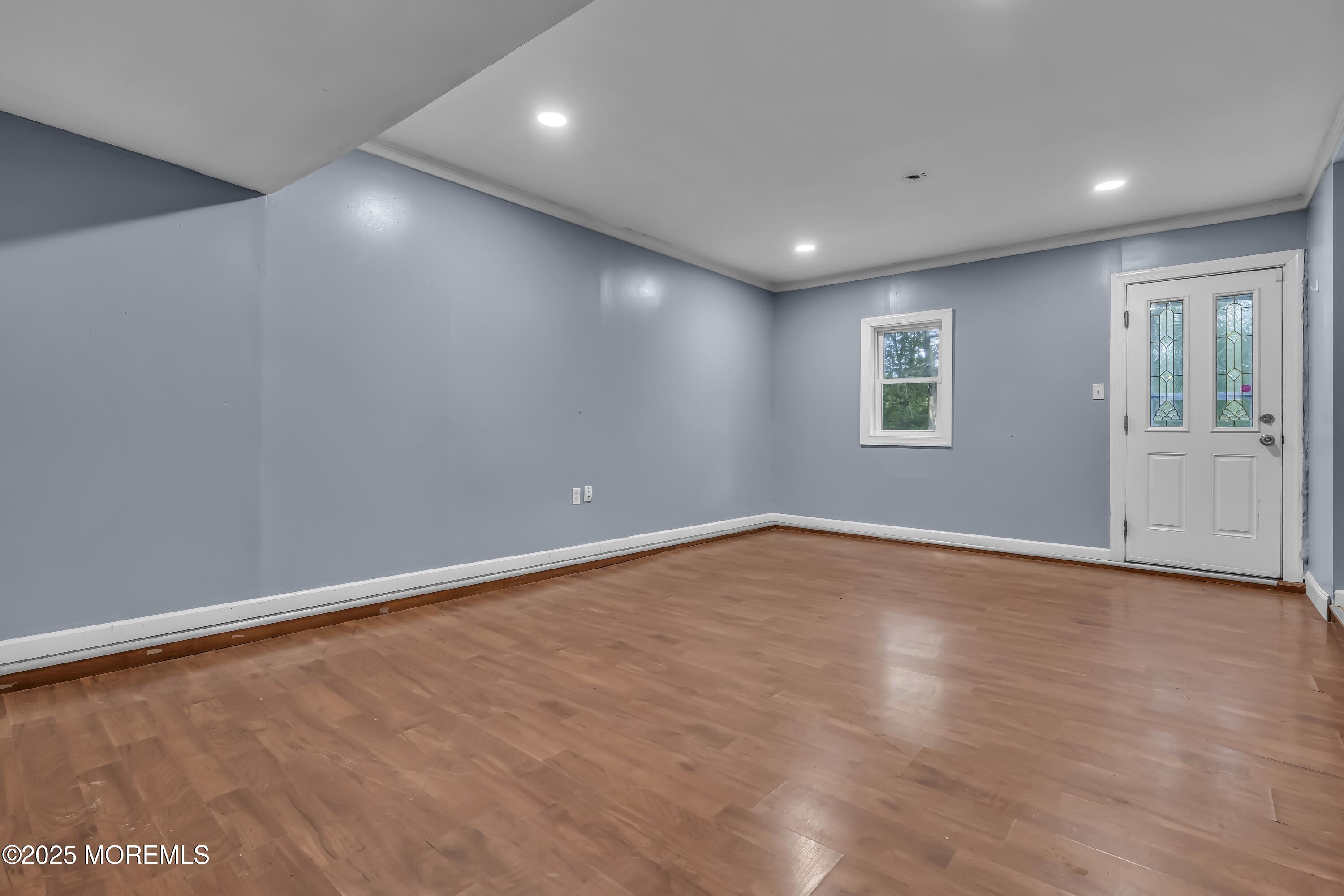 32 1st Street Barnegat, NJ 08005 - Photo 6 of 16 an empty room with wooden floor and windows
