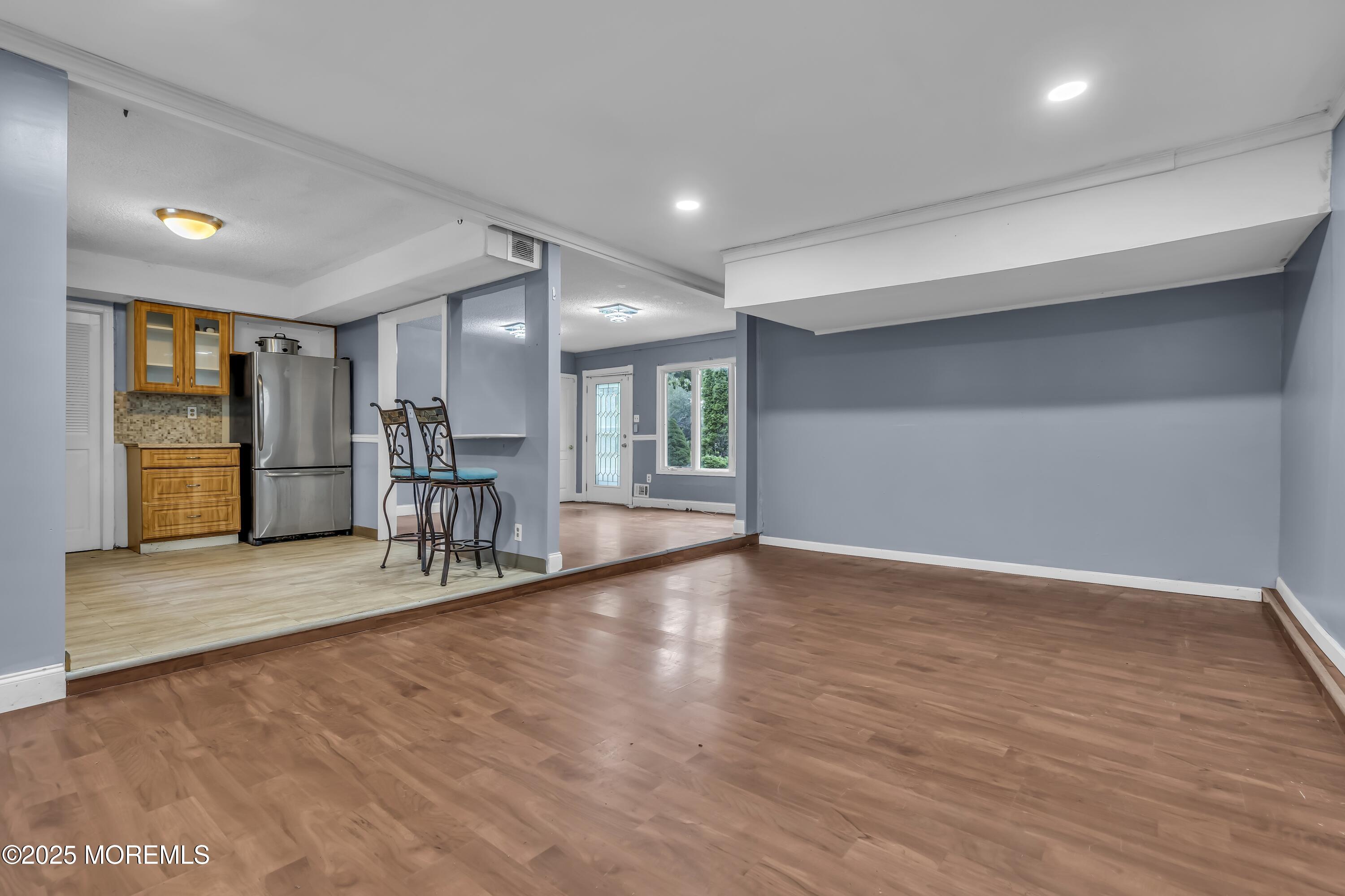32 1st Street Barnegat, NJ 08005 - Photo 7 of 16 a view of an empty room with wooden floor and a window