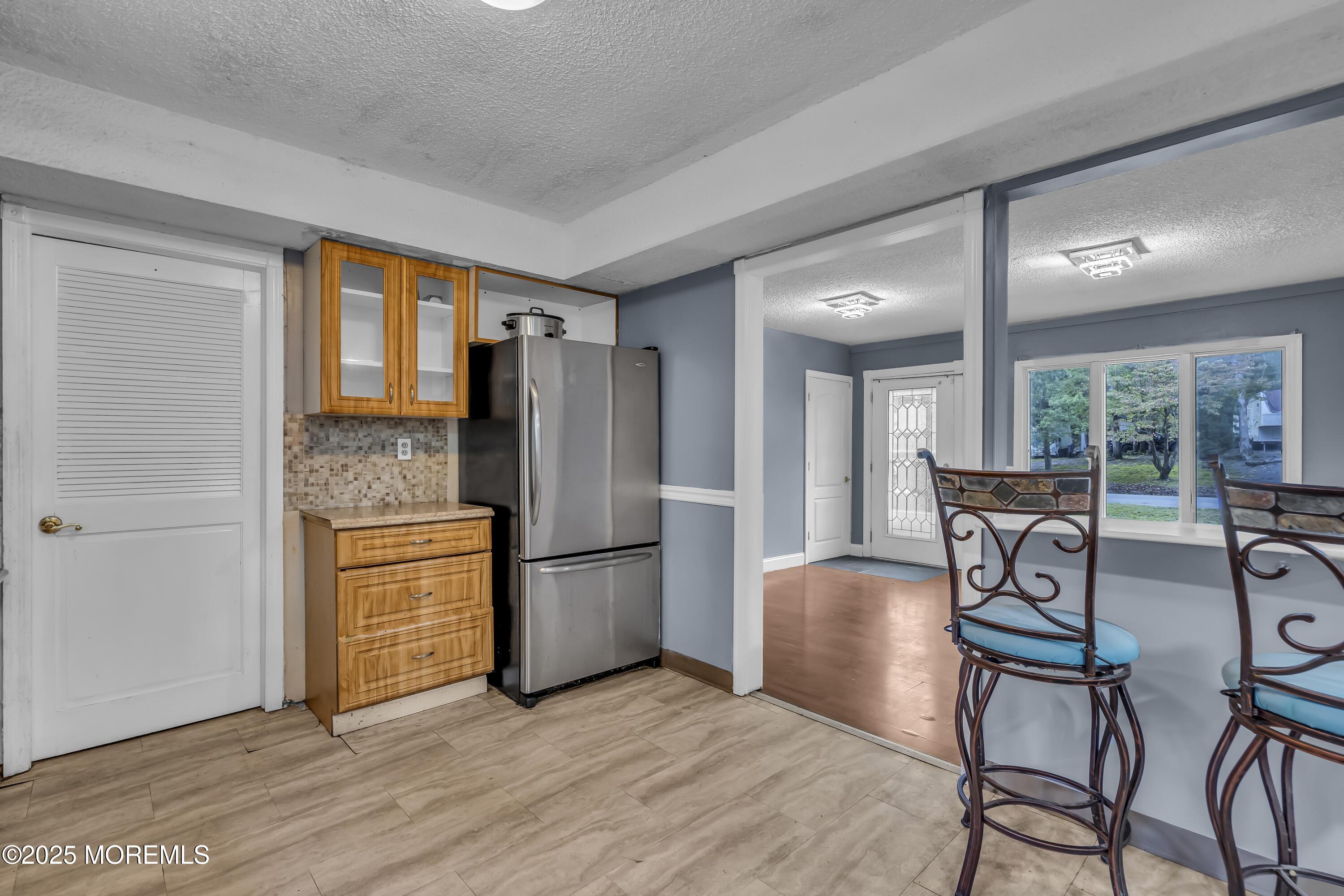 32 1st Street Barnegat, NJ 08005 - Photo 8 of 16 a kitchen with stainless steel appliances a refrigerator and wooden floor