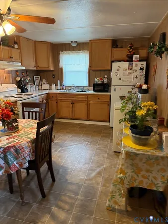 a kitchen with stainless steel appliances kitchen island granite countertop a sink and a refrigerator
