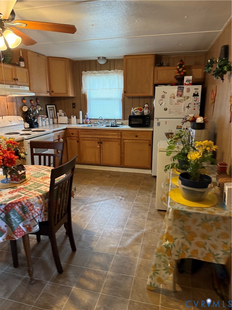 501 West 3rd Street Chase City, VA 23924 - Photo 12 of 14 a kitchen with stainless steel appliances kitchen island granite countertop a sink and a refrigerator