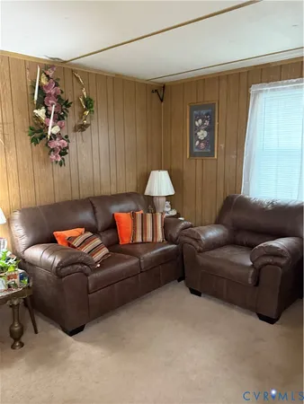 a living room with furniture a couch and a window