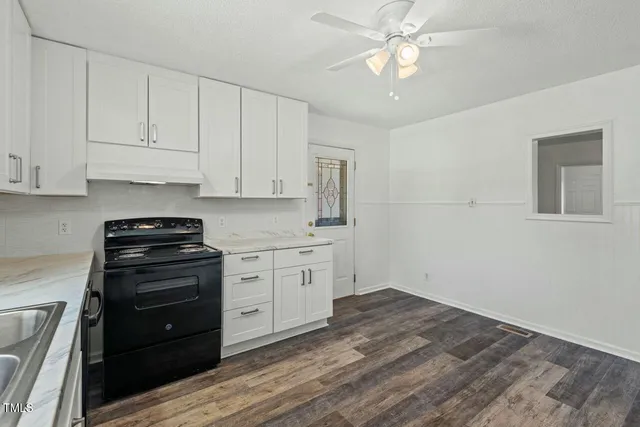 a kitchen with appliances cabinets and a sink